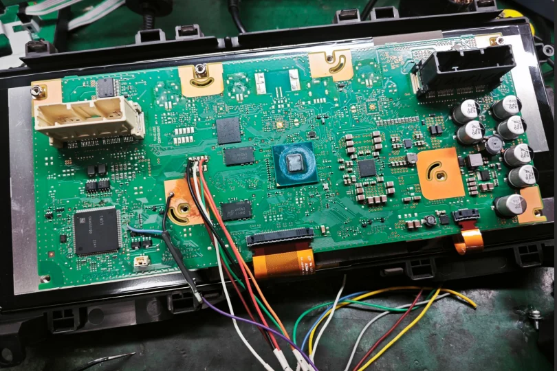 Toyota Camry instrument chips: Toyota Camry full LCD instrument cluster circuit board on a repair bench · 3